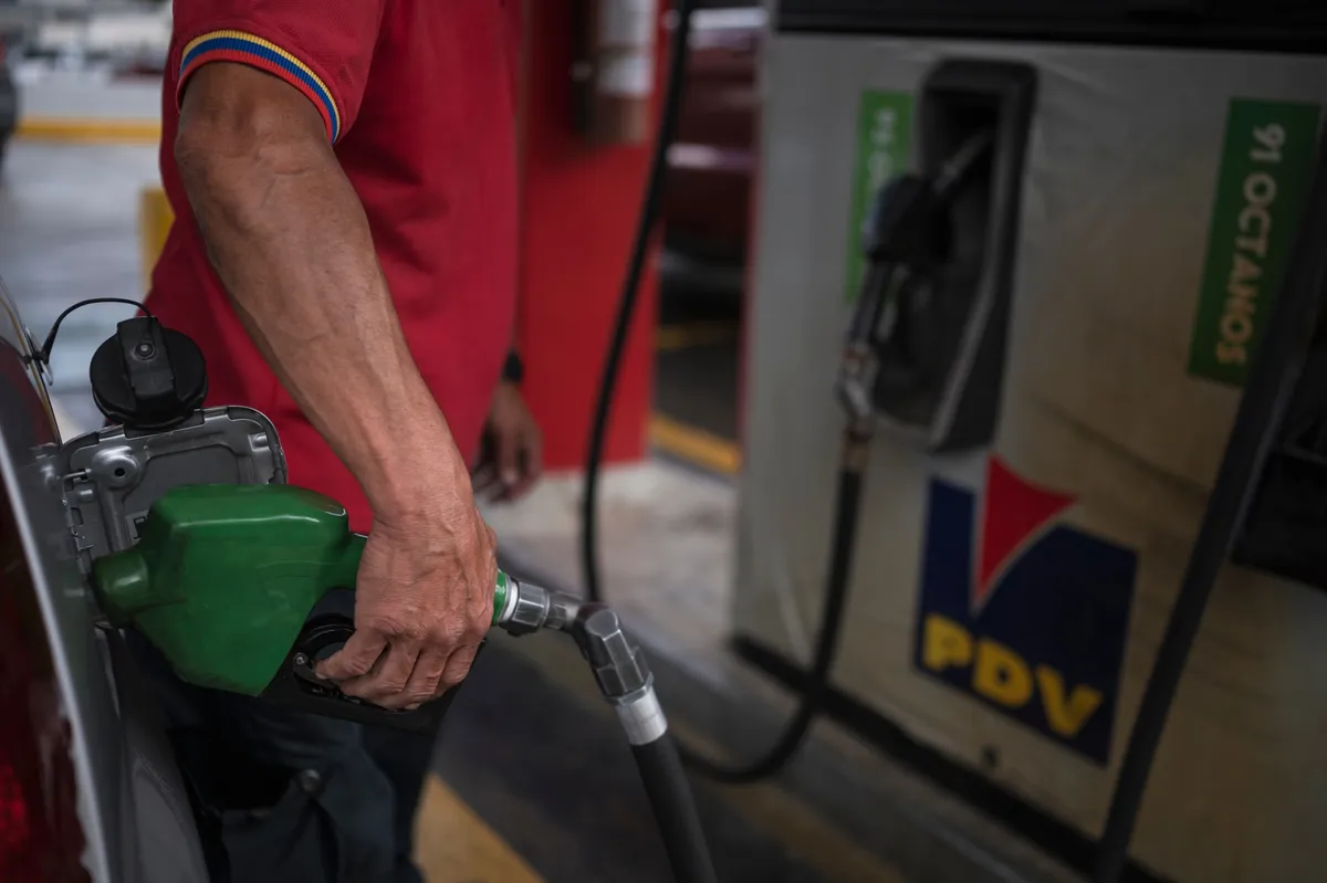 Un asistente bombea combustible a un vehículo en una gasolinera de PDVSA. Foto: Bloomberg