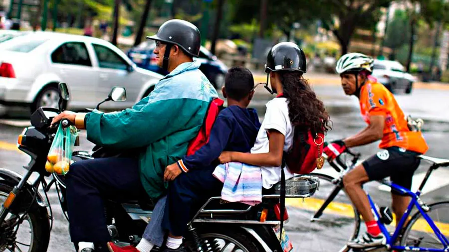 Motorizado con dos pasajeros, en Caracas.